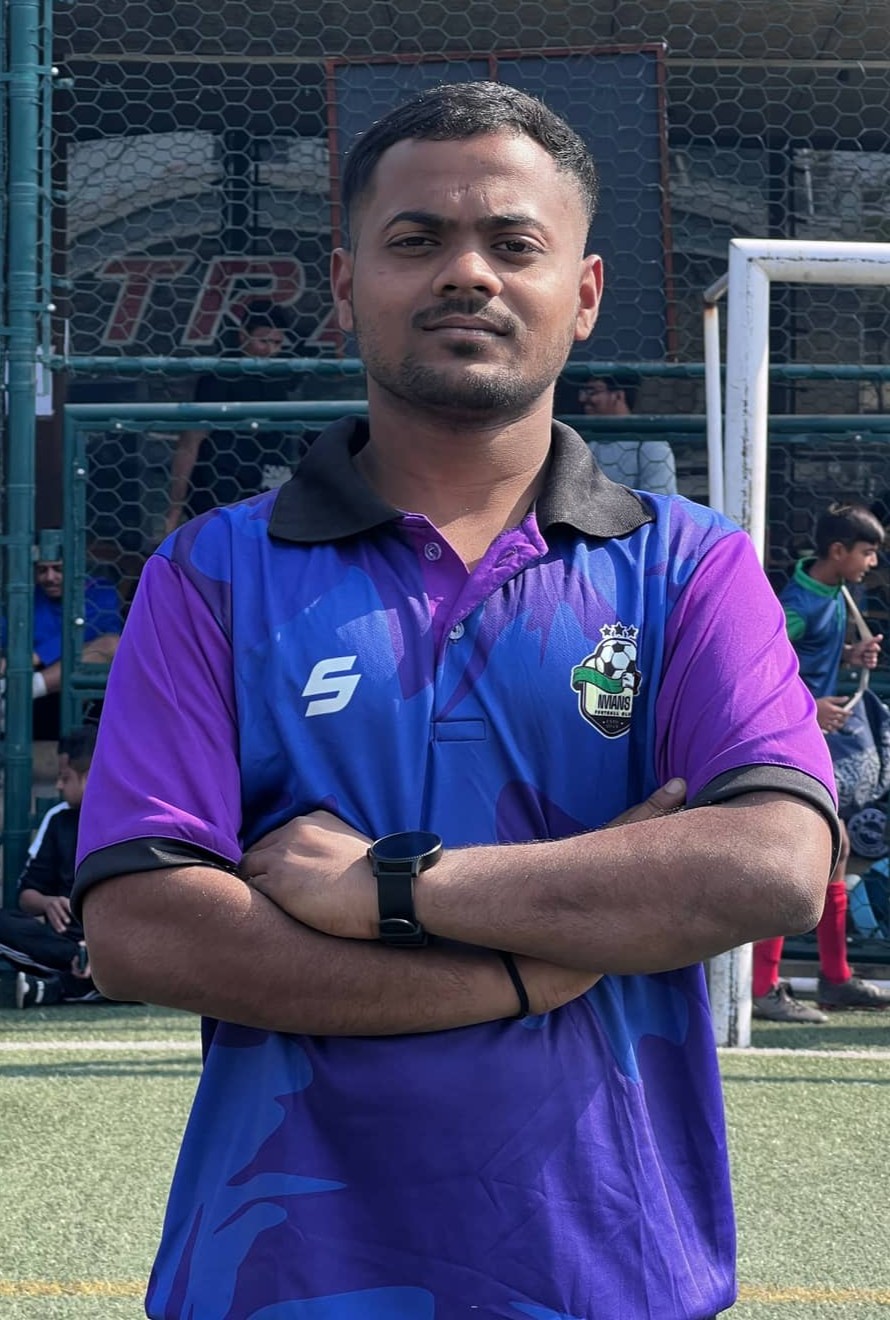 Sagar Pujari Coach Purple Blue Arms Crossed